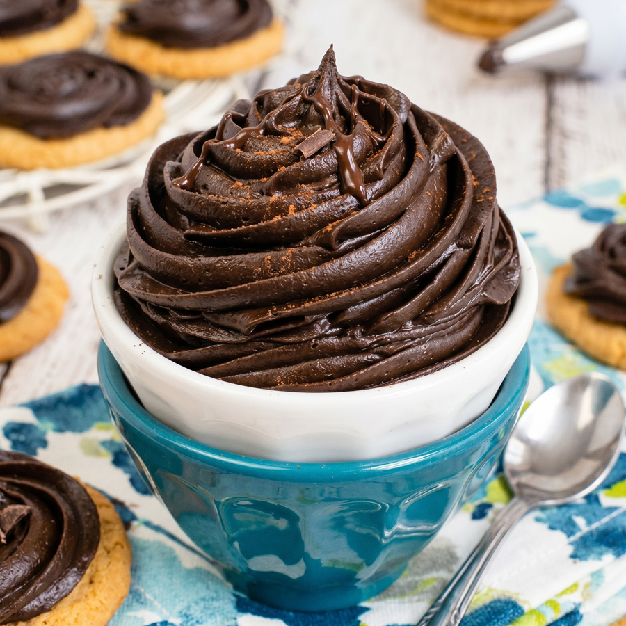 Ingredients for dark chocolate buttercream including butter, cocoa powder, powdered sugar, and cream